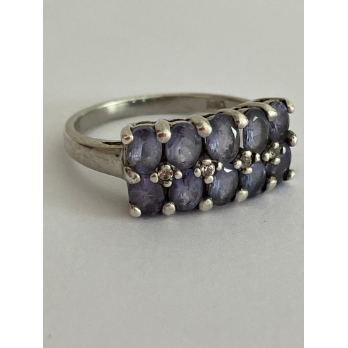 406 - TANZANITE and SILVER RING Consisting 10 oval cut Tanzanite gemstones Mounted in two rows and set wit... 