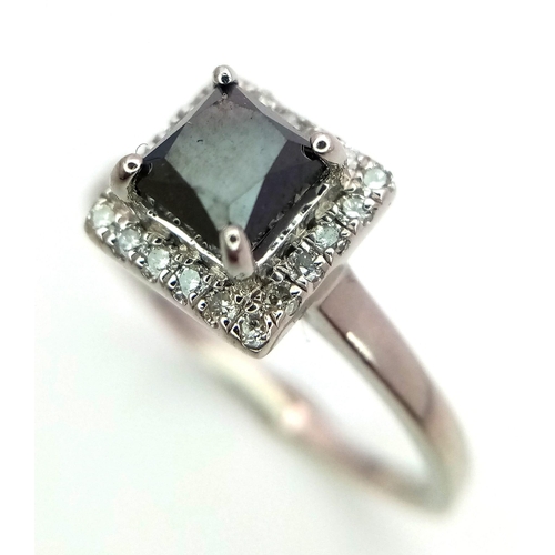 26 - A WGI certified platinum ring set with square-cut black diamond and a halo of twenty round brilliant... 