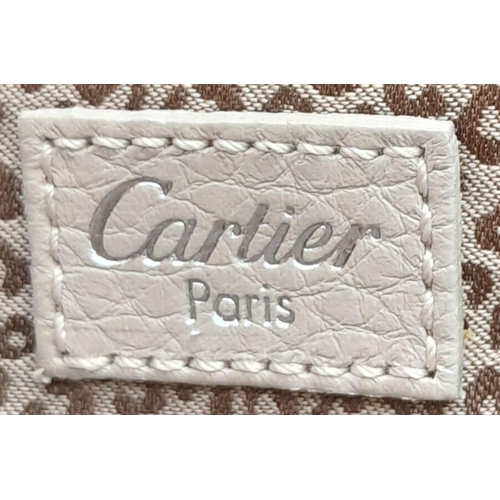 268 - A Cartier Beige Canvas and Leather Shoulder Bag. Fold over top closure. Silver-tone hardware. Leopar... 