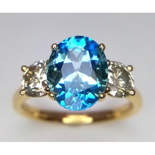 270 - A WGI certificated 18K yellow gold ring set with an oval-cut, eye-clean topaz - flanked by round bri... 