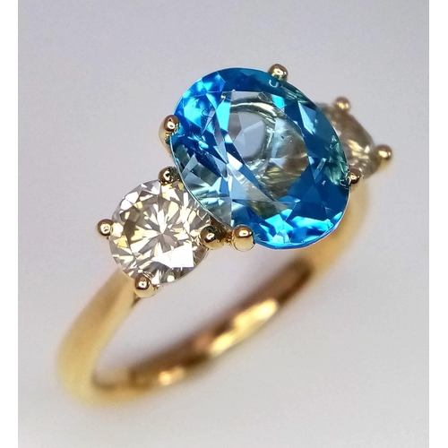 270 - A WGI certificated 18K yellow gold ring set with an oval-cut, eye-clean topaz - flanked by round bri... 