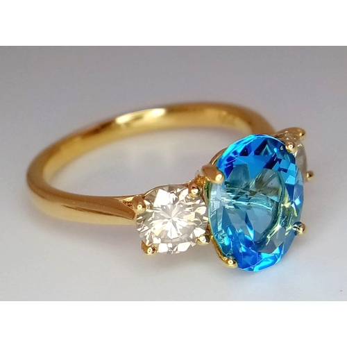 270 - A WGI certificated 18K yellow gold ring set with an oval-cut, eye-clean topaz - flanked by round bri... 