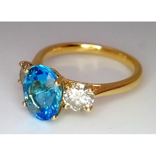 270 - A WGI certificated 18K yellow gold ring set with an oval-cut, eye-clean topaz - flanked by round bri... 