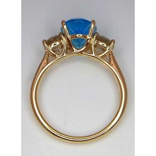 270 - A WGI certificated 18K yellow gold ring set with an oval-cut, eye-clean topaz - flanked by round bri... 