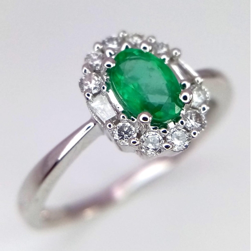 317 - A WGI certified oval cut emerald ring with round brilliant cut and baguette cut diamonds. Emerald - ... 