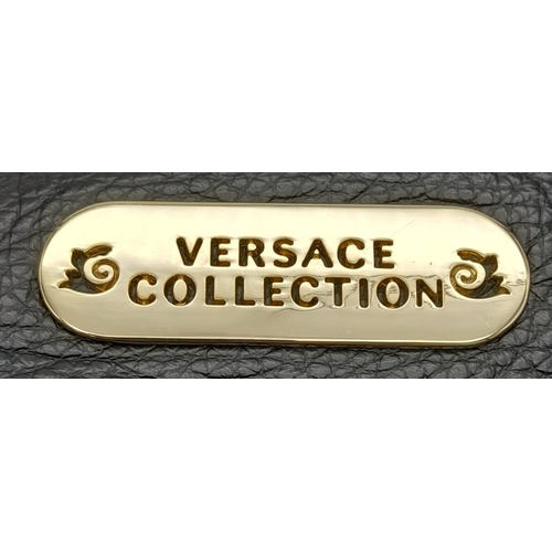 465 - A Versace Collection Black Textured Leather Handbag. Black leather exterior with gilded main zip. Go... 