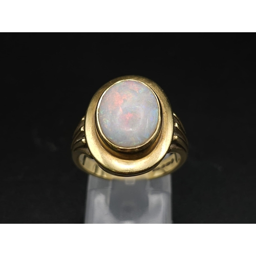 493 - AN 18K GOLD CORINTHIAN RING WITH OPAL CENTRE STONE . 7.6gms   size N/O