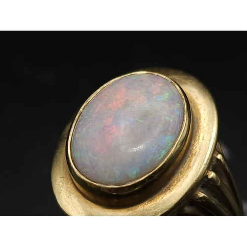 493 - AN 18K GOLD CORINTHIAN RING WITH OPAL CENTRE STONE . 7.6gms   size N/O