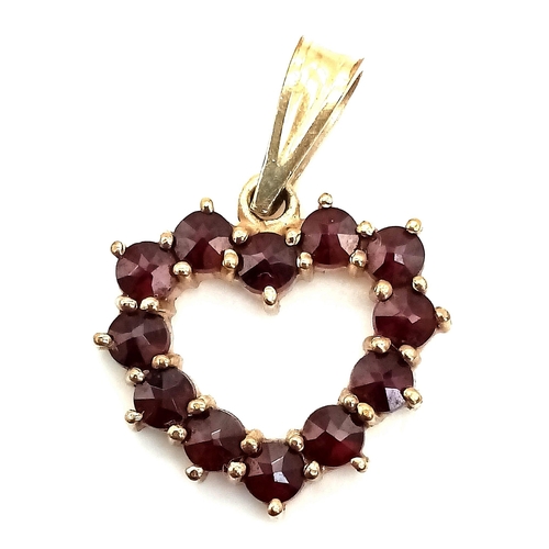 618 - 9K YELLOW GOLD GARNET SET OPEN HEART PENDANT

WEIGHT: 1.5G