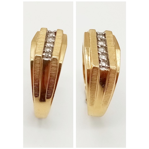 674 - A GENTS 14K GOLD RING WITH 5 DIAMONDS CHANNEL SET IN ATTRACTIVE DESIGN .   5.3gms   size Y