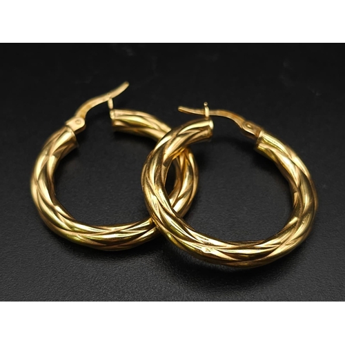 699 - A PAIR OF 9K GOLD TWIST HOOP EARRINGS .  2.15gms