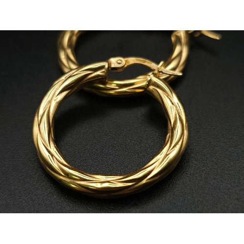 699 - A PAIR OF 9K GOLD TWIST HOOP EARRINGS .  2.15gms