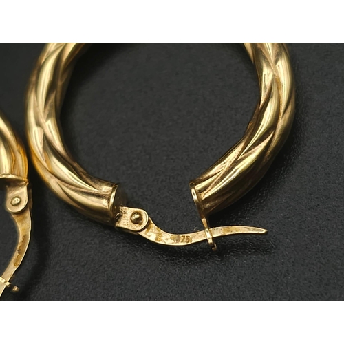 699 - A PAIR OF 9K GOLD TWIST HOOP EARRINGS .  2.15gms