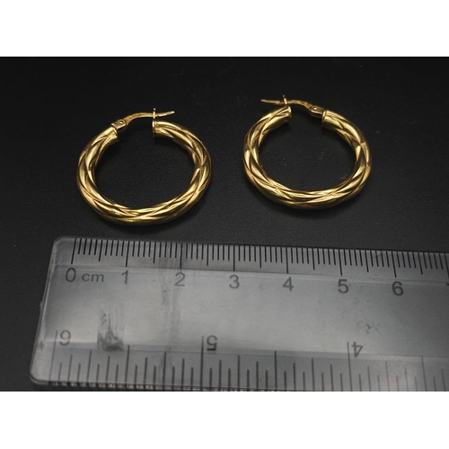 699 - A PAIR OF 9K GOLD TWIST HOOP EARRINGS .  2.15gms