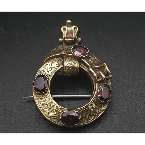 103 - An Antique Mid Karat Gold and Garnet Memorial/Union Brooch. Keeper belt design. Hair storage verso. ... 