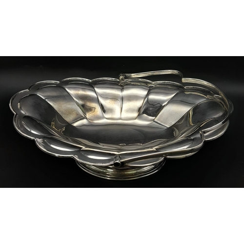 25 - A SOLID SILVER FRUIT DISH WITH HANDLE DATED 1912 AND MADE IN SHEFFIELD , NICE CONDITION FOR AGE .   ... 