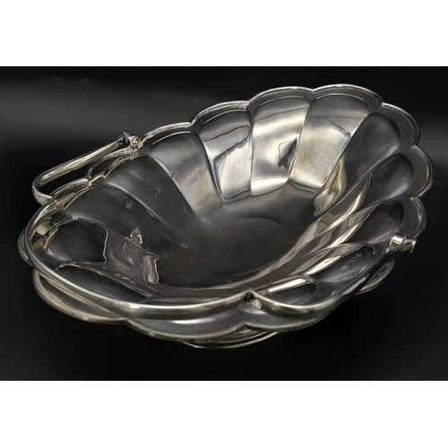 25 - A SOLID SILVER FRUIT DISH WITH HANDLE DATED 1912 AND MADE IN SHEFFIELD , NICE CONDITION FOR AGE .   ... 