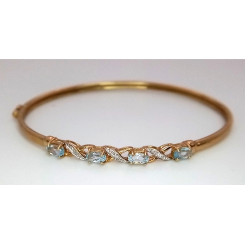 256 - An Italian 9K Yellow Gold Aquamarine and Diamond Clip Open Bangle. 6cm inner diameter. 4.05g total w... 