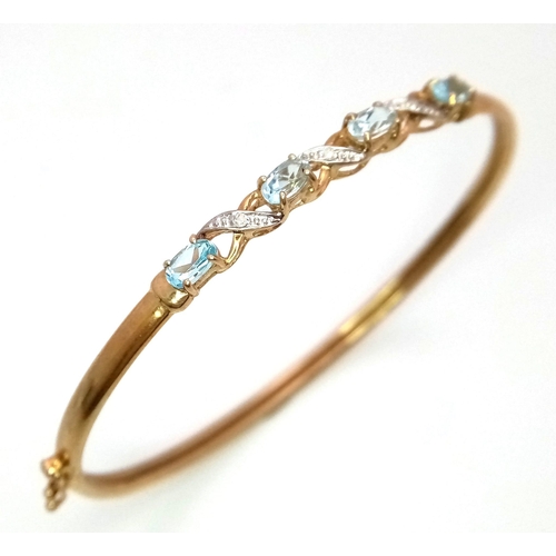 256 - An Italian 9K Yellow Gold Aquamarine and Diamond Clip Open Bangle. 6cm inner diameter. 4.05g total w... 