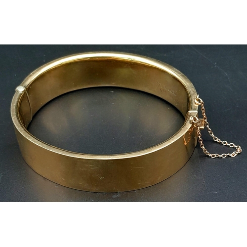 3 - A 9K GOLD NICELY DECORATED CUFF BANGLE WITH SAFETY CHAIN .    22.5gms