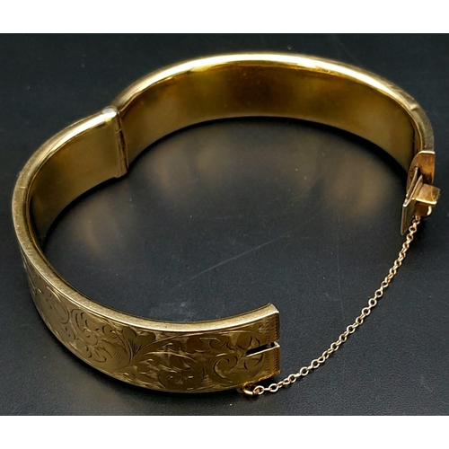 3 - A 9K GOLD NICELY DECORATED CUFF BANGLE WITH SAFETY CHAIN .    22.5gms