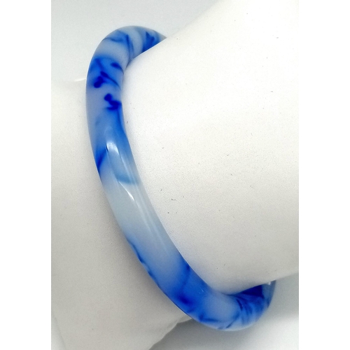 747 - A Thin Blue and White Chinese Swirl Jade Bangle. 6cm inner diameter. 8mm width