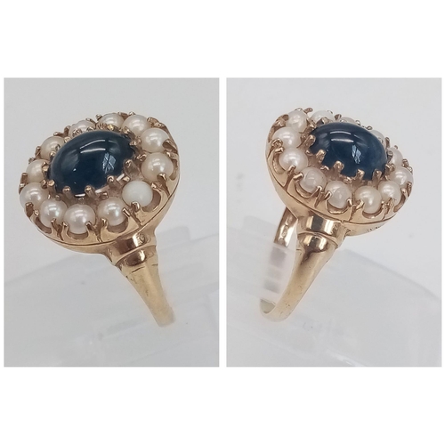 891 - A 9K GOLD RING WITH CENTRAL SAPPHIRE SURROUNDED BY SEED PEARLS .  2.9gms   size M/N