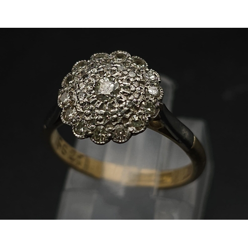 745 - A Vintage 18K Yellow Gold and Platinum Diamond Ring. An array of diamonds in a platinum setting. Siz... 