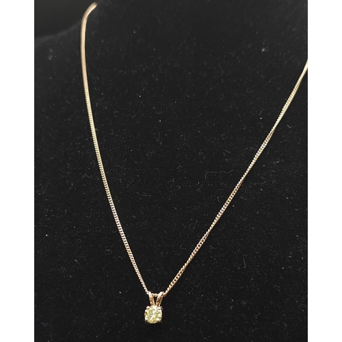 193 - A WGI certified 18K rose gold solitaire pendant set with a fancy yellow round brilliant cut diamond ... 