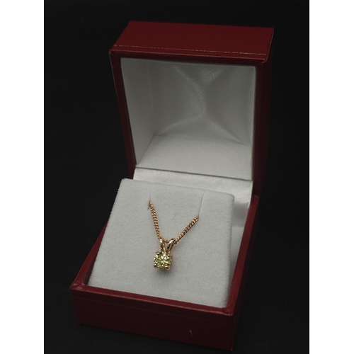 193 - A WGI certified 18K rose gold solitaire pendant set with a fancy yellow round brilliant cut diamond ... 