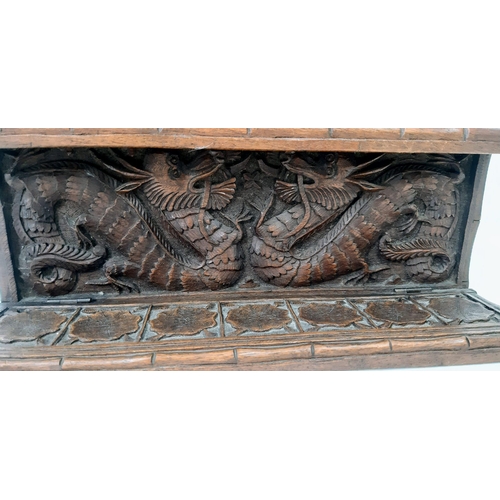 242 - An Antique (circa 1840) Chines Hand Carved Wood Opium Pipe Rack. Dragon decoration throughout.  31cm... 