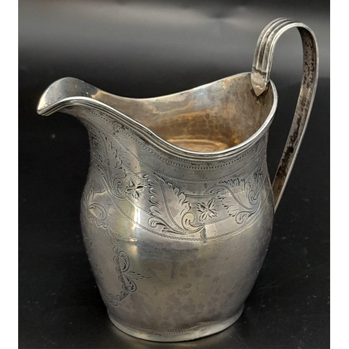 689 - An Antique George III Sterling Silver Cream Jug. Hallmarks for London 1800. 11cm tall. 93.3g weight.