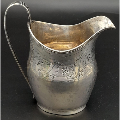 689 - An Antique George III Sterling Silver Cream Jug. Hallmarks for London 1800. 11cm tall. 93.3g weight.