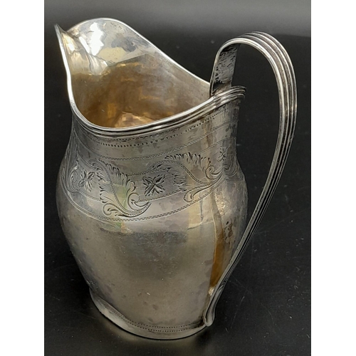 689 - An Antique George III Sterling Silver Cream Jug. Hallmarks for London 1800. 11cm tall. 93.3g weight.