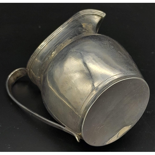 689 - An Antique George III Sterling Silver Cream Jug. Hallmarks for London 1800. 11cm tall. 93.3g weight.