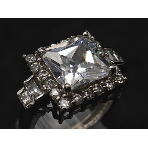 927 - A Stunning Ex Display Tier Mounted Cubic Zirconia Set Ring, Size P. 
Set with a 1cm Square Cut raise... 