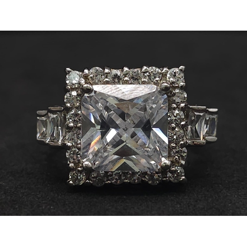 927 - A Stunning Ex Display Tier Mounted Cubic Zirconia Set Ring, Size P. 
Set with a 1cm Square Cut raise... 