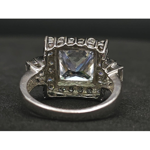 927 - A Stunning Ex Display Tier Mounted Cubic Zirconia Set Ring, Size P. 
Set with a 1cm Square Cut raise... 