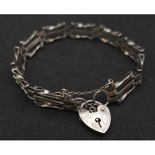 1010 - A VINTAGE SILVER GATE BRACELET WITH HEART PADLOCK  .  11.2gms