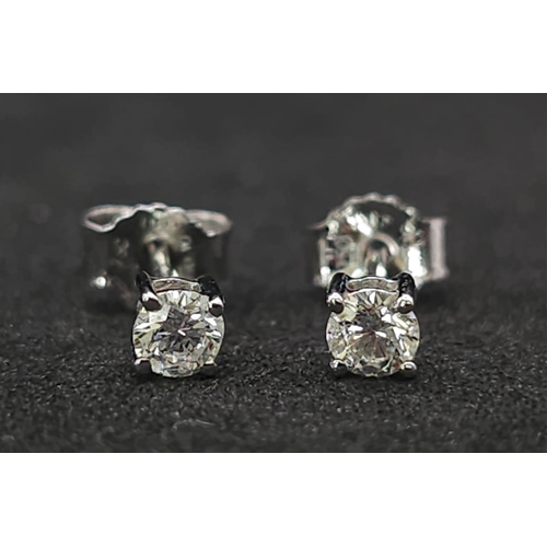 582 - A Pair of 18K White Gold Diamond Stud Earrings. 0.2ctw. As new. 0.51g total weight.