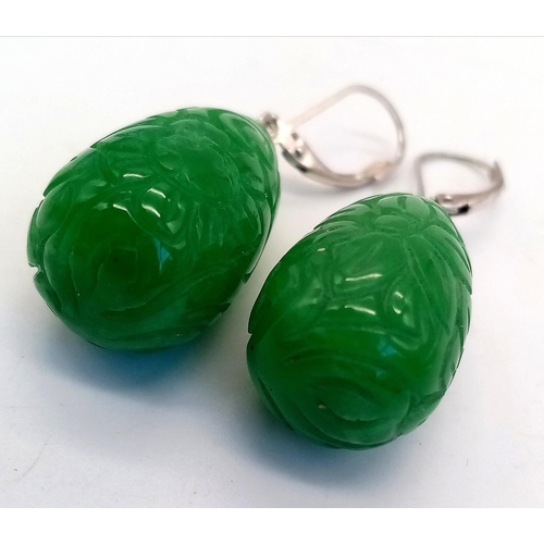 556 - A Pair of Jade Carved Teardrop Earrings. Silver clasps.