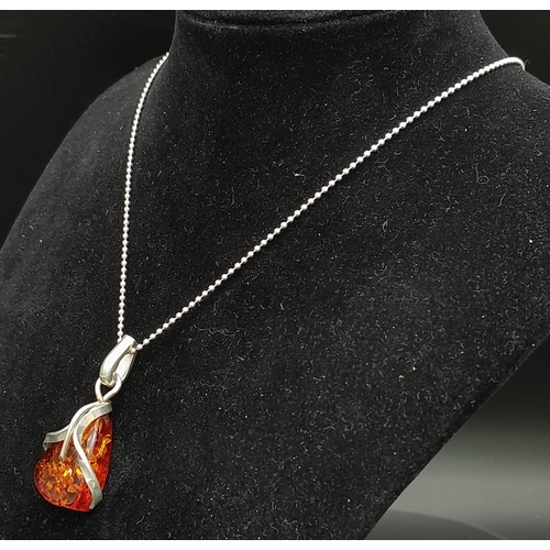 675 - A Vintage Modernist Design, Sterling Silver and Amber Set Pendant Necklace.

46cm Length, set with a... 