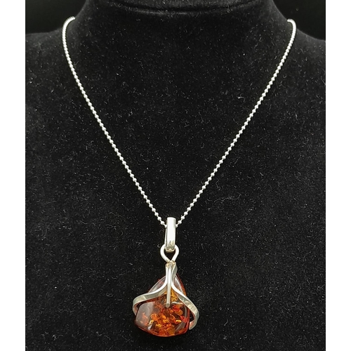 675 - A Vintage Modernist Design, Sterling Silver and Amber Set Pendant Necklace.

46cm Length, set with a... 