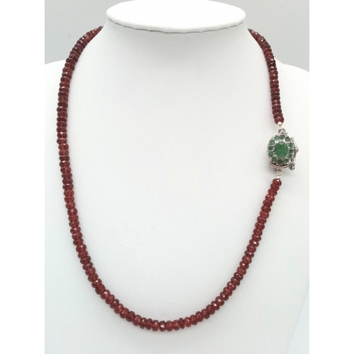 697 - A 125ct Spessartite garnet Necklace with Emerald and 925 silver Clasp. 42cm.