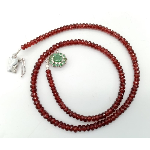 697 - A 125ct Spessartite garnet Necklace with Emerald and 925 silver Clasp. 42cm.