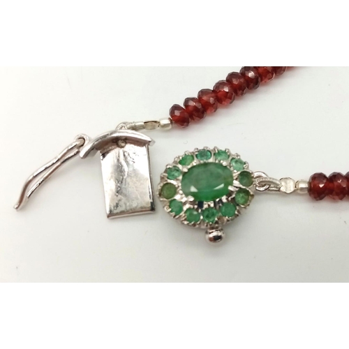 697 - A 125ct Spessartite garnet Necklace with Emerald and 925 silver Clasp. 42cm.