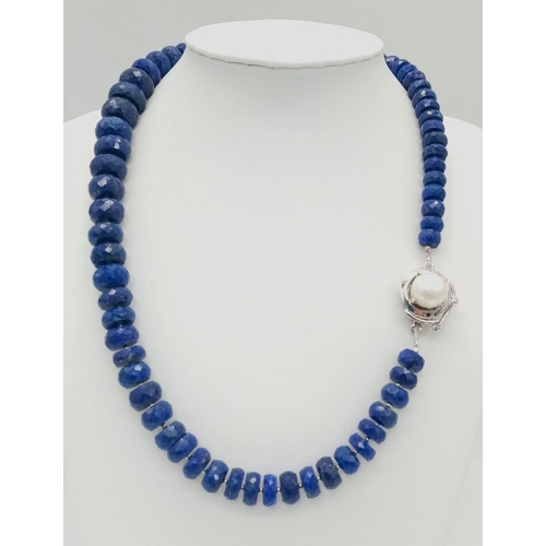 720 - A 375ct Graduated Lapis Lazuli Faceted Bead Necklace with Pearl and 925 Silver Clasp. 44cm length.