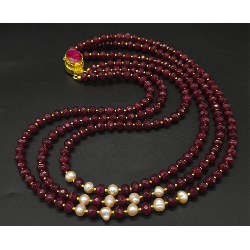 141 - A three strand necklace with multifaceted rubies and genuine pink pearls with a complimenting facete... 