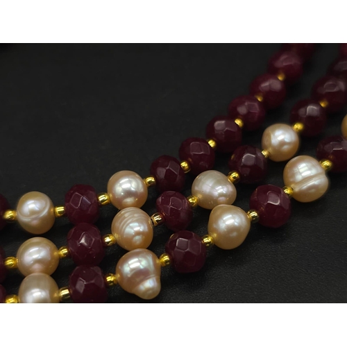 141 - A three strand necklace with multifaceted rubies and genuine pink pearls with a complimenting facete... 