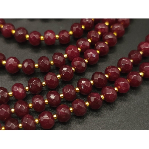 141 - A three strand necklace with multifaceted rubies and genuine pink pearls with a complimenting facete... 